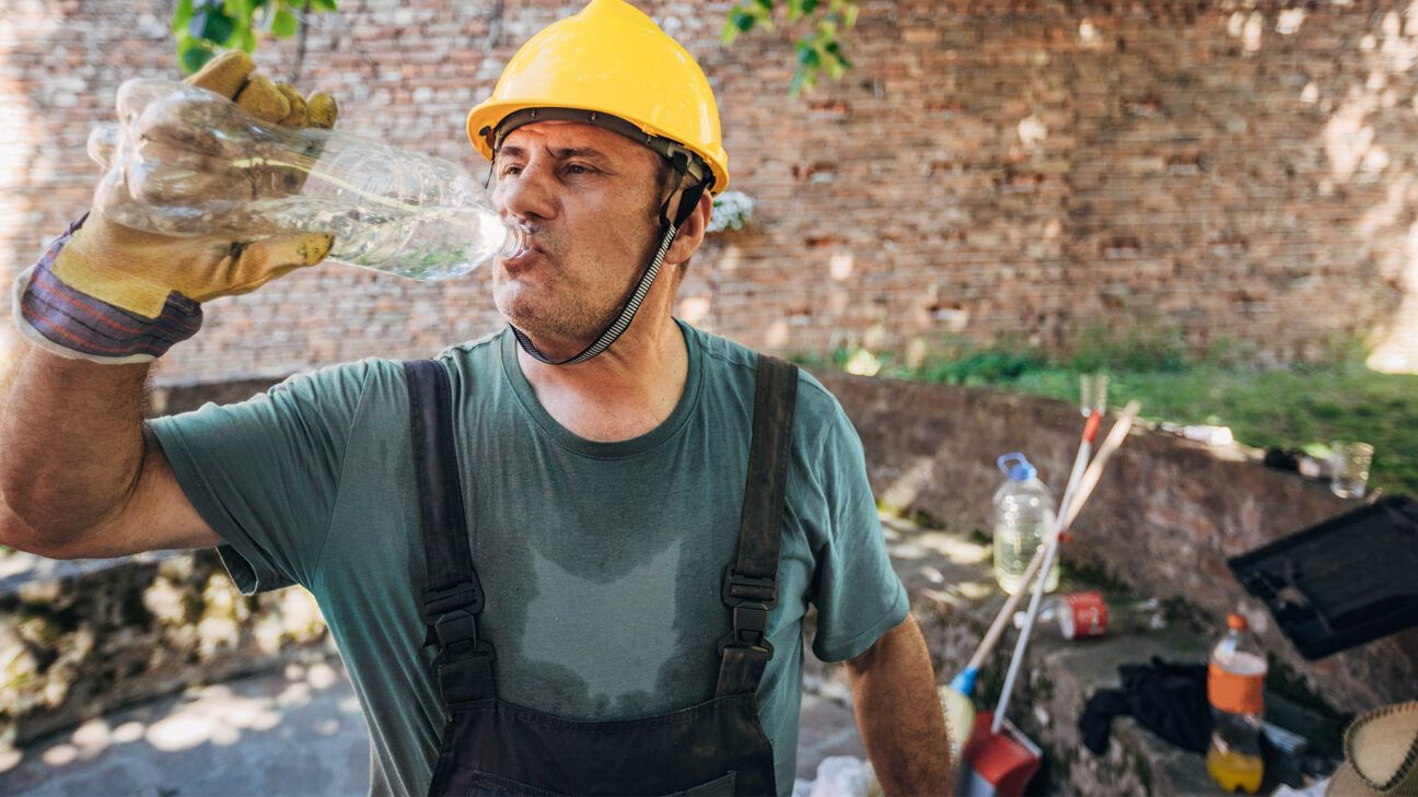 Construction worker cooling off in the heat.